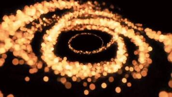 abstrakt rörelse av gyllene gnistrande glitter partiklar skapande en virvlande magisk virvel på en svart bakgrund. video