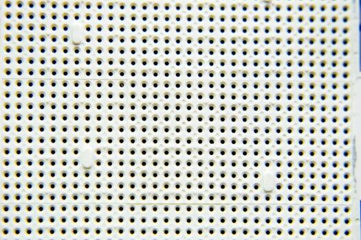 A socket under the processor of the computer, holes under the fe7et of the contacts. Electronic board with electrical components. Electronics of computer equipment photo