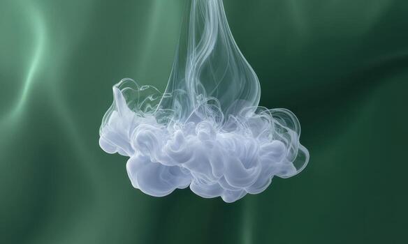 Delicate white ink dispersing in clear water, forming an ethereal cloud against a green background photo