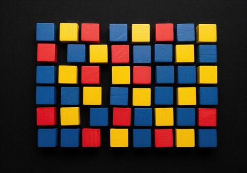 Vibrant primary colored wooden blocks arranged in a grid pattern on a dark surface photo