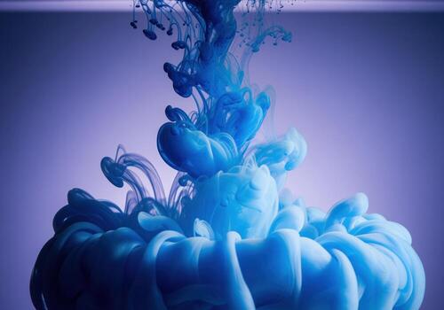Mesmerizing blue ink swirling and dispersing in clear water, creating an abstract fluid art pattern photo