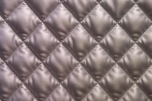 Luxurious quilted satin fabric with diamond pattern and soft raised padding texture photo