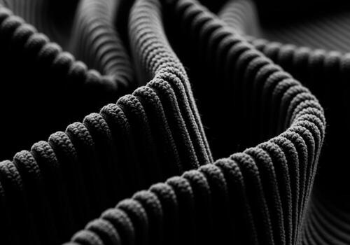 Extreme macro photography of deep black, heavily textured corduroy fabric textile structure photo