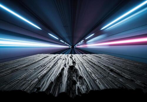 Textured black wood display surface in a futuristic tunnel with motion blur light trails photo