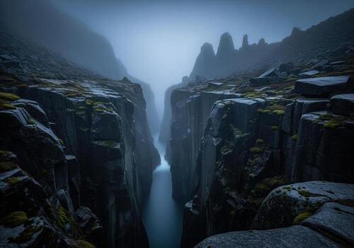 Massive fog shrouded gorge in a cold northern climate with dark slate gray cliffs and misty atmosphere photo