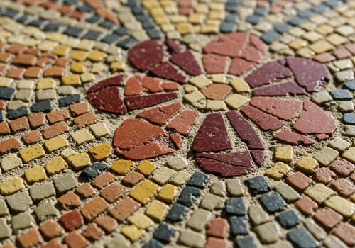 Close up of an ancient roman style mosaic with intricate floral pattern and colorful tesserae photo
