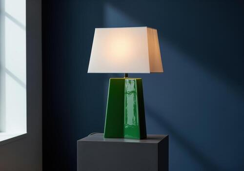 Modern table lamp with a vibrant glossy emerald green geometric ceramic base and a clean white rectangular shade photo