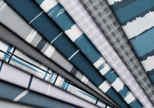 Fan like arrangement of contemporary fabric samples with blue and grey patterns photo