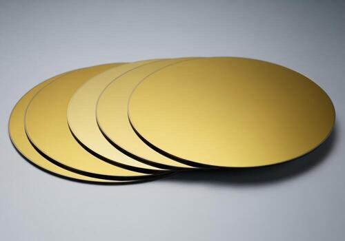 Stack of five clean, polished gallium arsenide wafers with uniform deep gold color photo