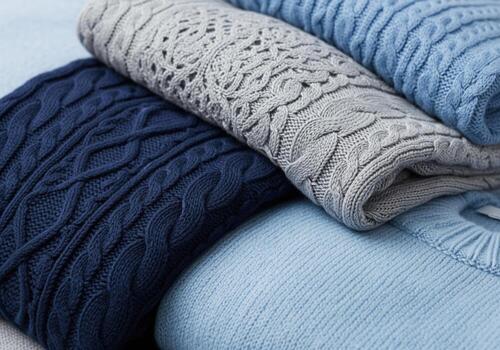Luxurious cashmere sweaters in blue and grey, showcasing diverse knit patterns photo