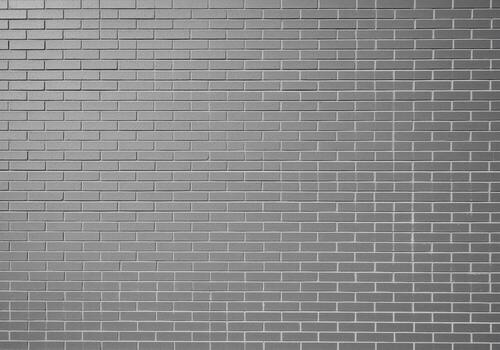 Contemporary grey brick wall texture with uniform smooth bricks and clean mortar lines photo