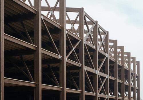 Multi story commercial building under construction with exposed timber frame structure photo