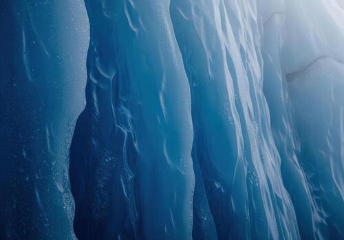 Abstract close up of deep blue glacial ice texture forming vertical frozen ridges. photo