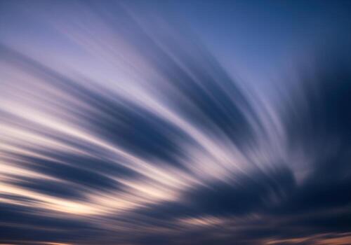 Dramatic long exposure sky with streaking clouds during twilight blue hour photo