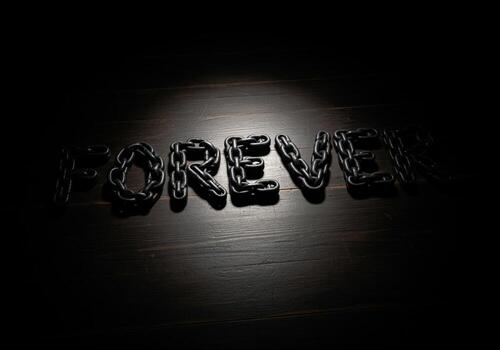 Dark, intense word FOREVER created using strong, heavy metal chains photo