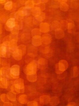 Abstract orange bokeh light background with soft circular shapes photo
