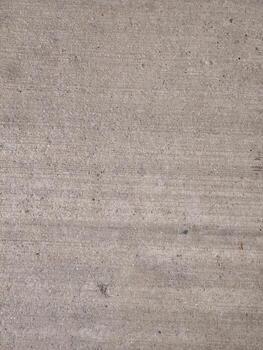 Close up of textured gray concrete surface background with subtle lines and specks photo