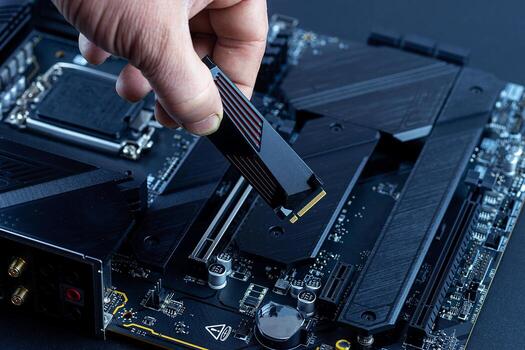 Personal computer technicians mounting ssd drive on the motherboard socket, pc assembling. photo