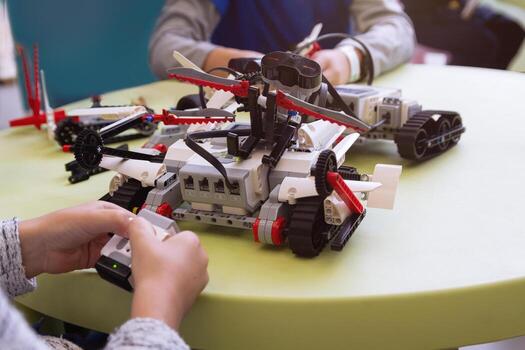 Children are working on model assembly in robotics class. Tachnology photo