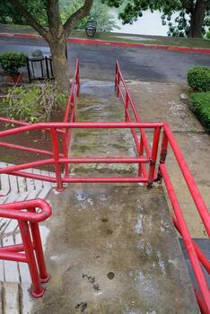 Wet Ramp with Red Railings in Garden Setting photo