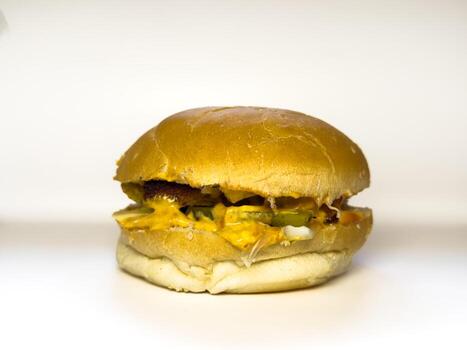 Homemade chicken burger with cheese sauce and soft buns. copy space, white background close up photo