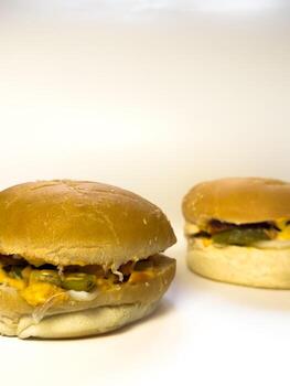 Homemade beef burger with cheese sauce and soft buns. copy space, white back photo