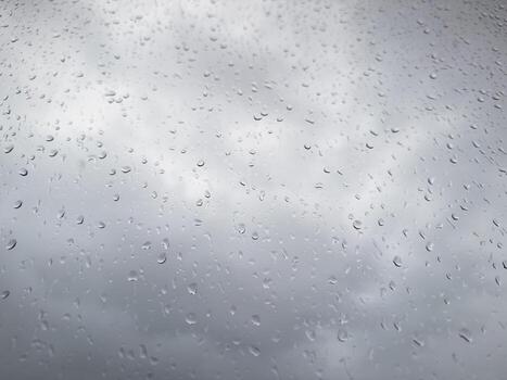 Raindrops on the window, rain in the city, cloudy weather, wet window after rain photo