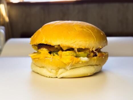 Homemade beef burger with cheese sauce and soft buns. copy space, white photo