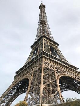 The Eiffel Tower is lit up at day. Symbol of Paris and France closeup photo