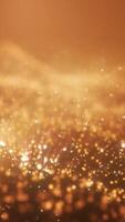 Warm abstract background with glowing golden particles and bokeh lights creating a festive and dreamy atmosphere video
