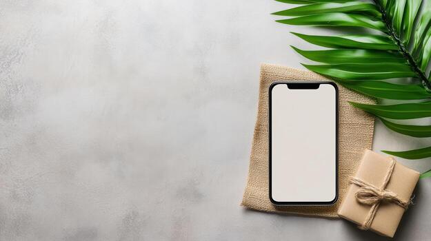 Smartphone with blank screen and gift box on a gray background photo
