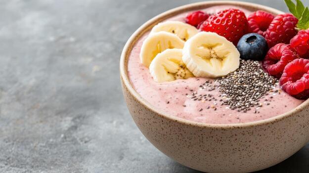A bowl of fruit smoothie with berries, bananas and chia seeds photo
