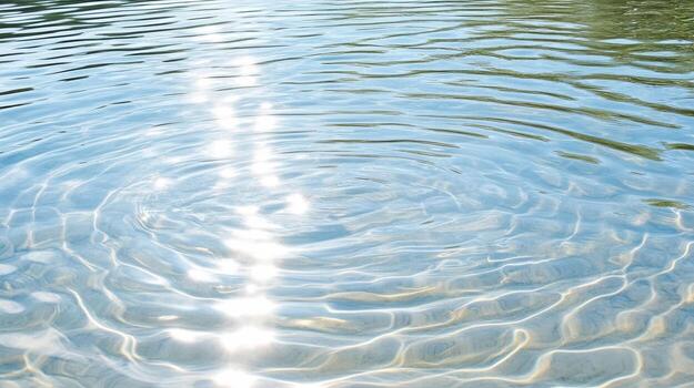 A ripple in the water with sunlight shining through photo