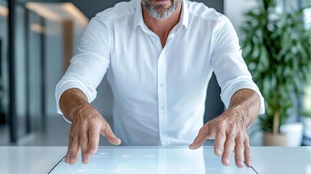 A man is using a touch screen in an office photo