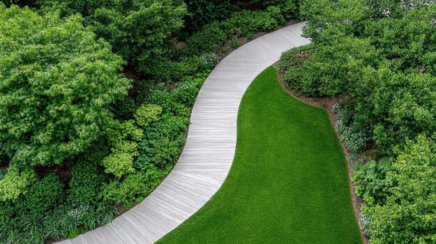 An aerial view of a green lawn and a wooden path photo