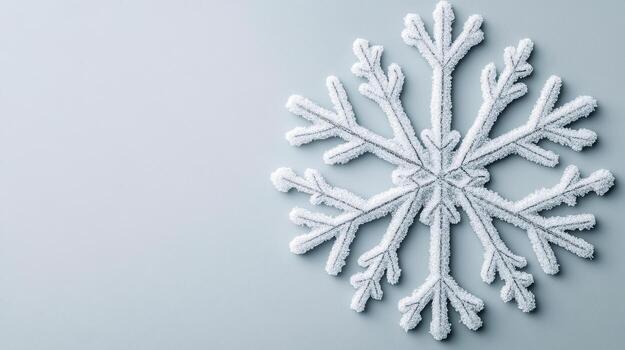 A snowflake is shown on a gray background photo