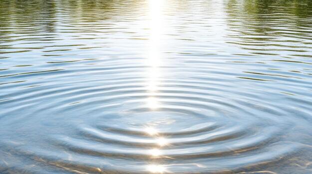 A ripple in the water with a sun shining through photo