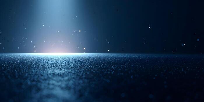 A dark blue abstract background features a bright glowing light on a textured surface with floating particles photo