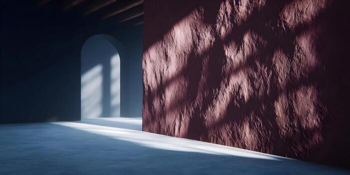 Sunlight streams into a minimalist architectural space illuminating a textured brown wall and an archway with contrasting shadows photo