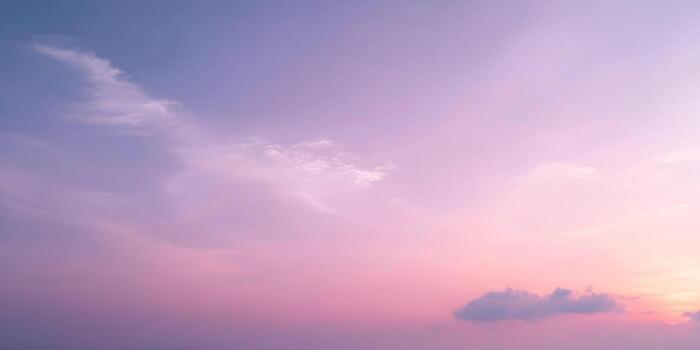 A beautiful pastel gradient sky with soft clouds creating a serene and dreamy atmosphere photo