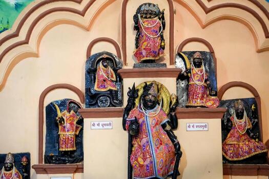 A group of statues in a temple with a wall behind them photo