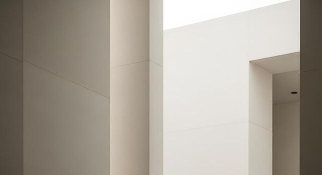 Detailed view of a contemporary architectural exterior with smooth white walls, sharp angles, and a play of light and shadow creating a minimalist background photo