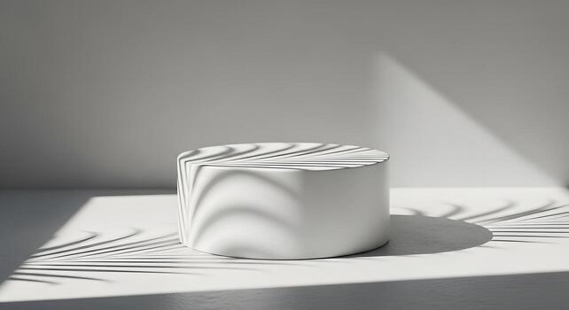 Minimalist white podium casting delicate leaf shadows, creating a serene and elegant display for product presentation photo