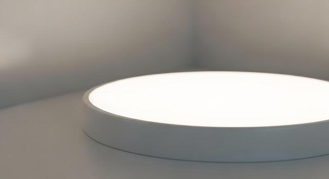 Minimalist Circular LED Light Fixture on White Surface with Soft Lighting, Ideal for Product Display photo