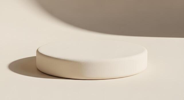 Minimalist cream round podium on a monochromatic background with soft, natural shadows, creating an elegant setting for product presentations or abstract conceptual displays photo