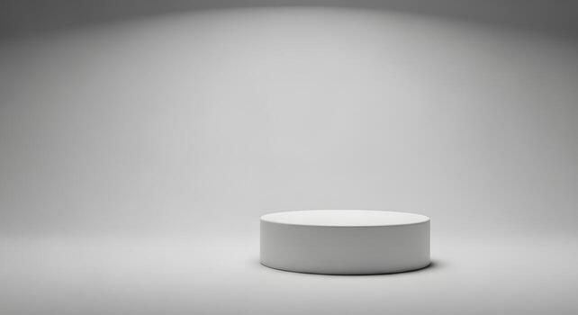 Sleek minimalist white cylindrical display podium illuminated by a gentle spotlight in an empty studio space, ideal for product presentations and graphic design mockups photo