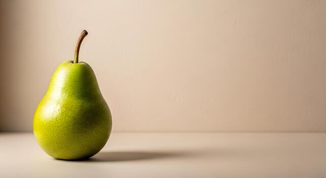 A single, vibrant green pear rests on a smooth, neutral surface, bathed in soft light, creating a minimalist and elegant food still life composition photo