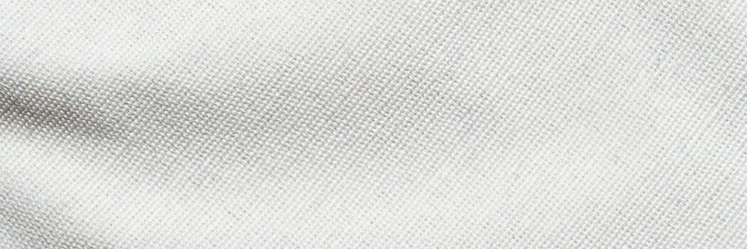 Cream-colored fabric texture with subtle weave pattern perfect for design and fashion projects. photo