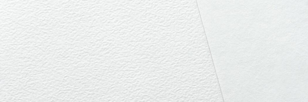 Close-up texture of two types of white paper with different finishes and subtle patterns. photo