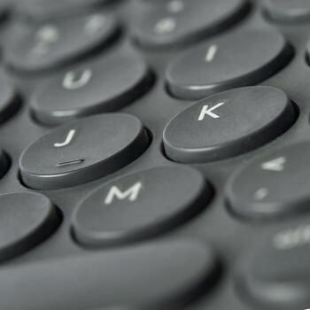 Close-up view of black computer keyboard keys with j, k, and m visible. photo